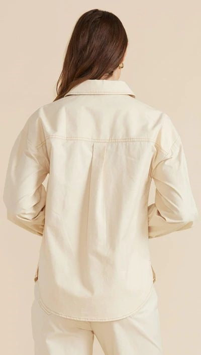 The Mink Pink Zala Shacket is great to wear on it's own or layered over other tops. Features include a collared neckline, boxy oversized fit, tortoise-shell buttons on a crisp ecru base.