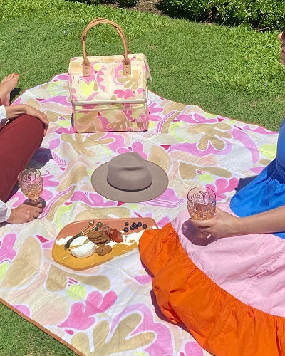 The Somewhere Co. Golden Girl Picnic Rug is perfect for lounging around with your crew. The velvety fabric makes your picnic extra luxurious. This rug fits 4 people comfortably with its 150cm X 200cm size. It has a adjustable and removable vegan leather strap and a sturdy carry handle. Made from fleece with a waterproof lining underside.